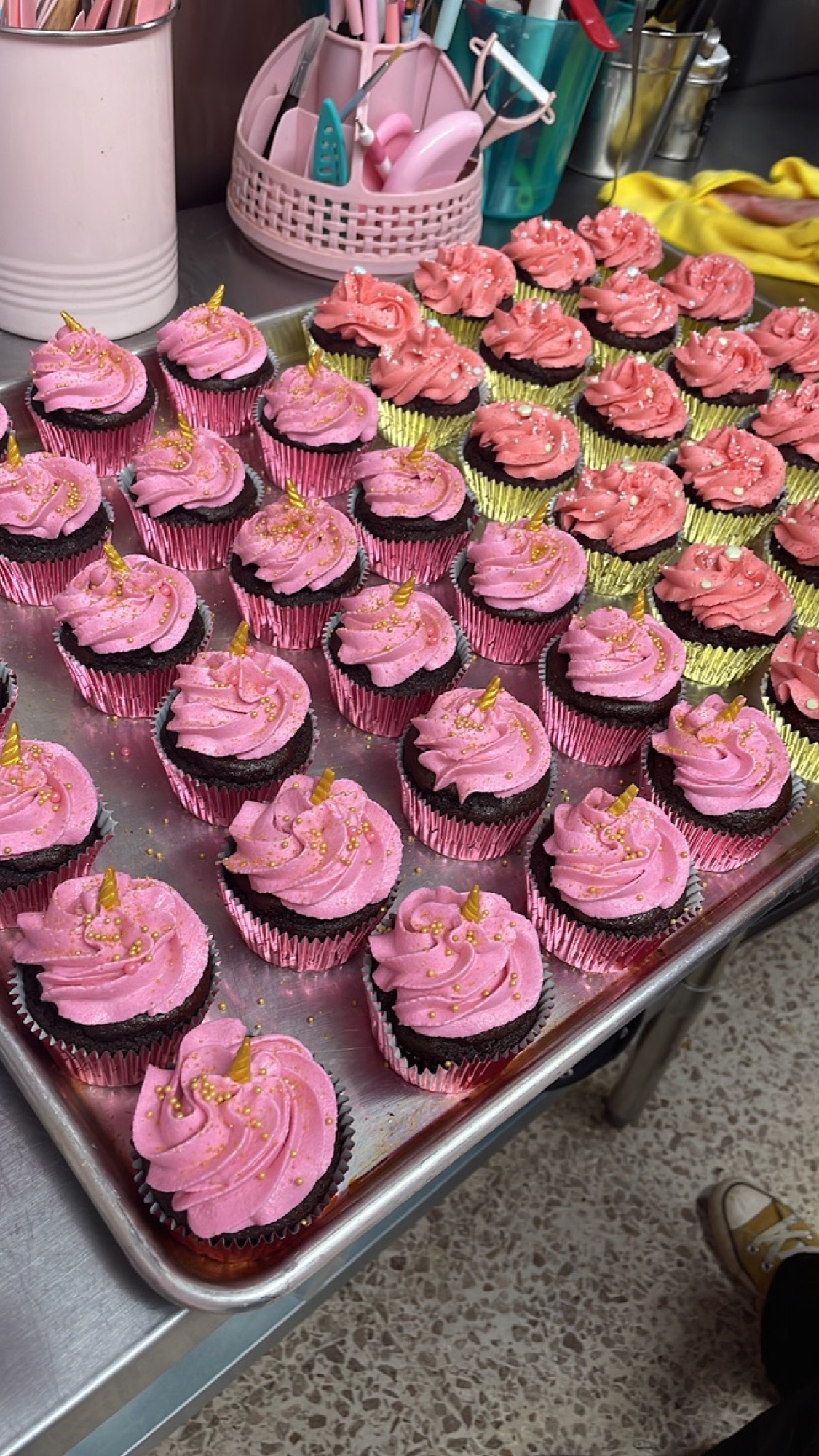 Rows of pink-frosted gluten-free cupcakes