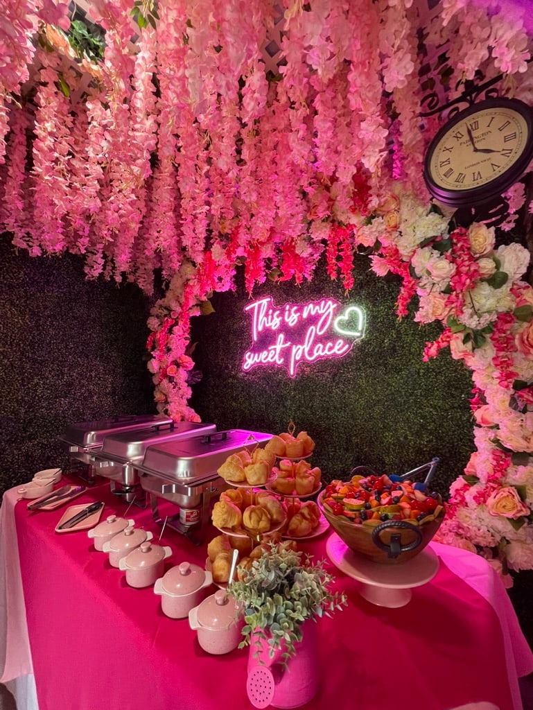 A Wabbles event spread beneath the pink flower wall
