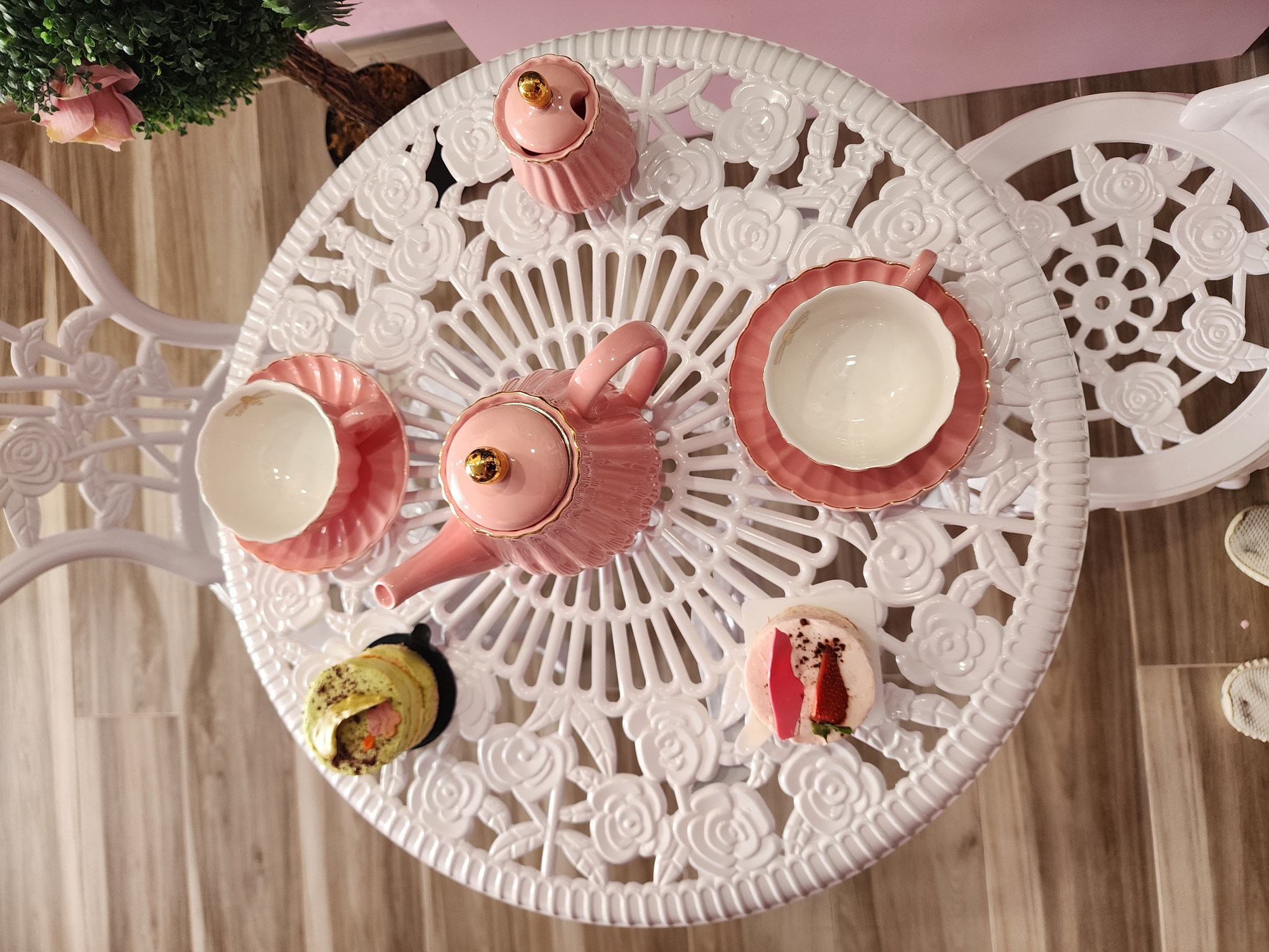 Tea and sweets on a white garden table